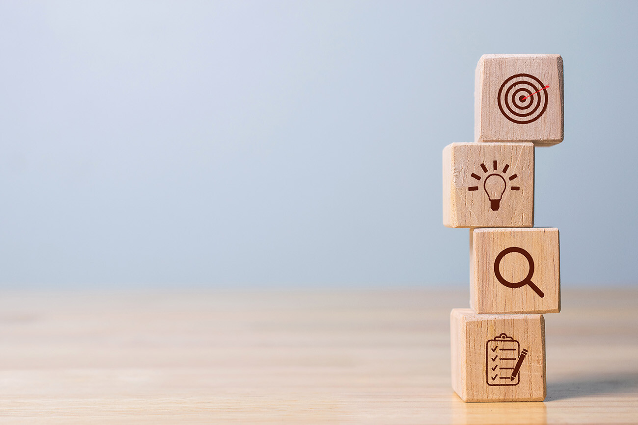 stacked wood blocks with action plan symbols