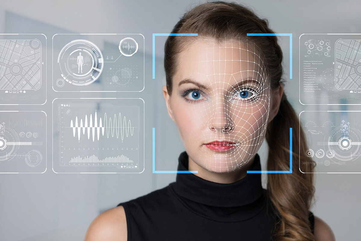 Woman with virtual icons over and around face using facial recognition