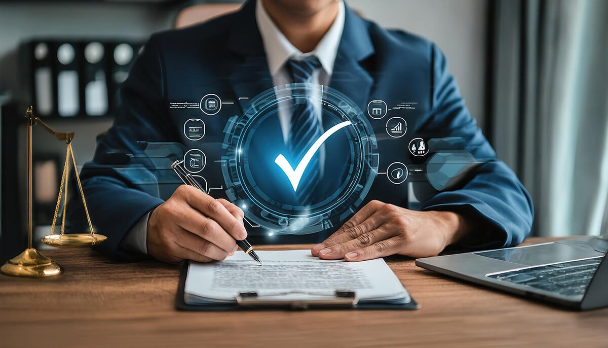 Man sitting at desk with clipboard of papers with virtual check mark icon