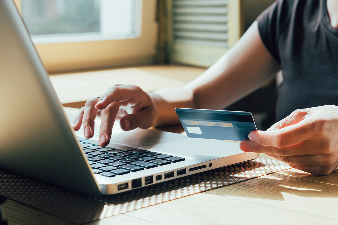 Person entering credit card information into computer