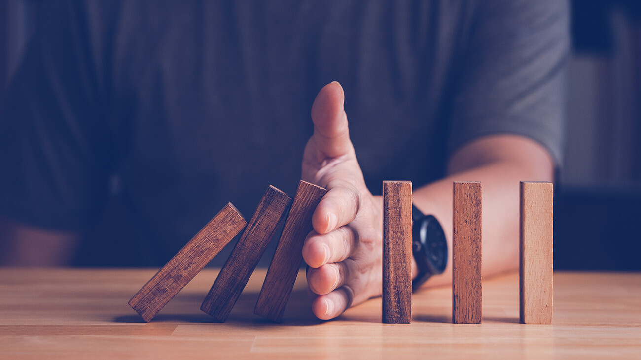 hand stopping wood block domino