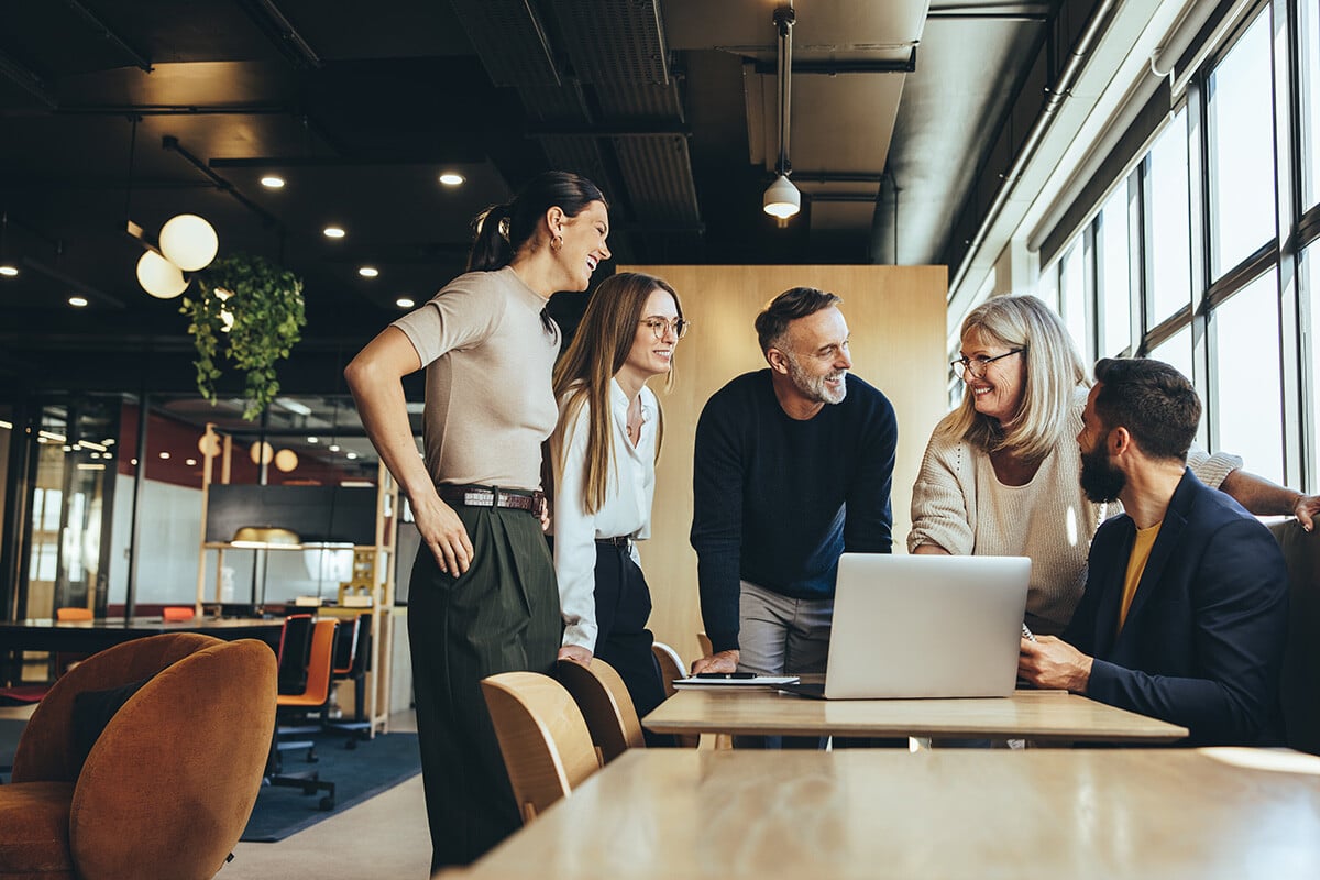 Colleagues collaborating around a computer