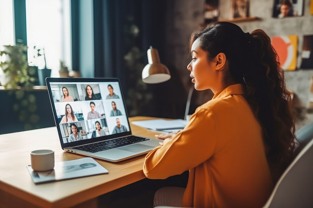 Back view of female employee talking on video call with colleagues