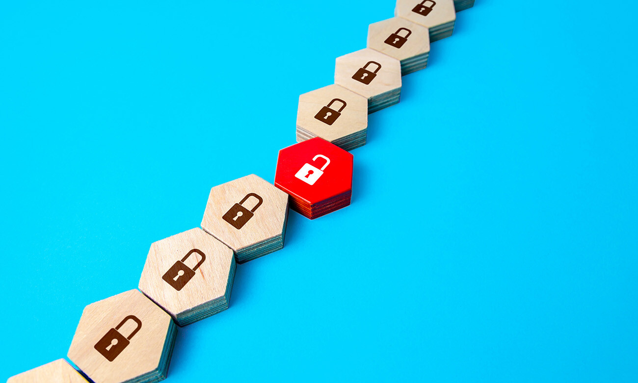 wood blocks with locked padlocks, one red block with open padlock