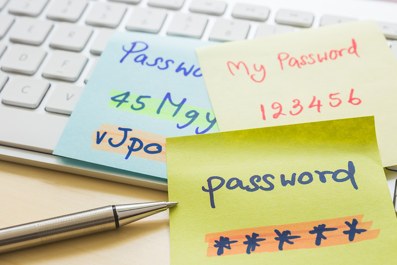 pen and post-it notes with passwords written on them