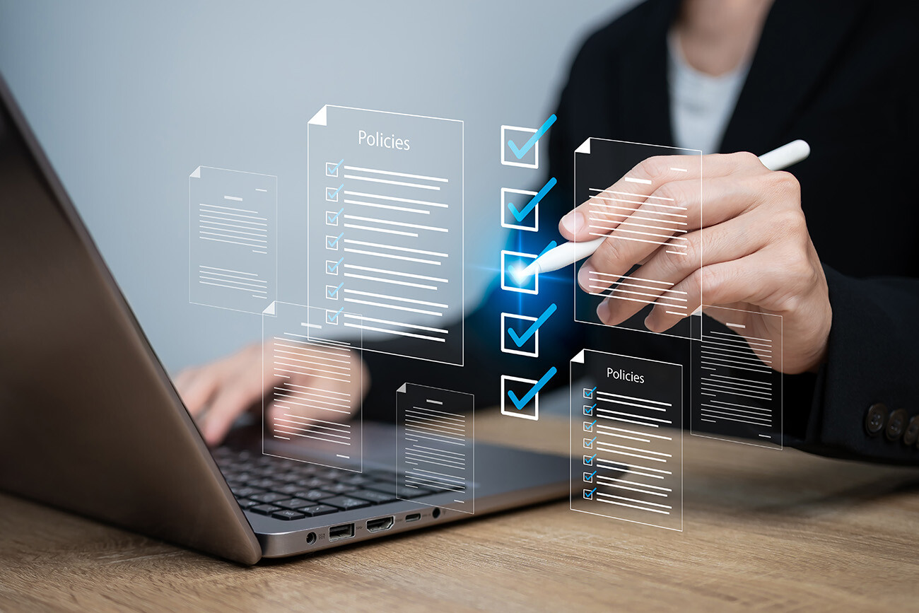 Person working on computer checking off policies