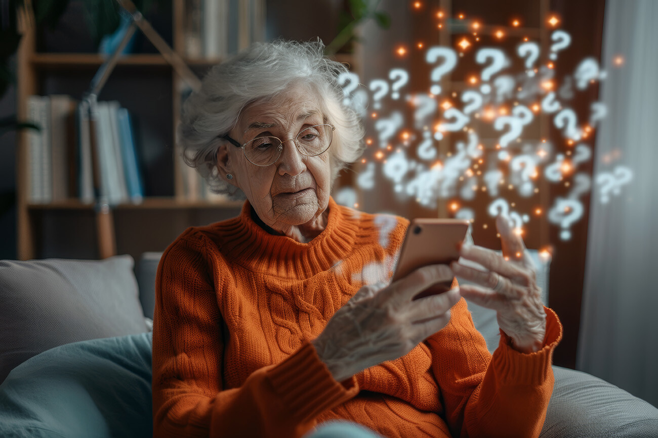 Elderly woman looking at cell phone with questions marks surrounding the phone